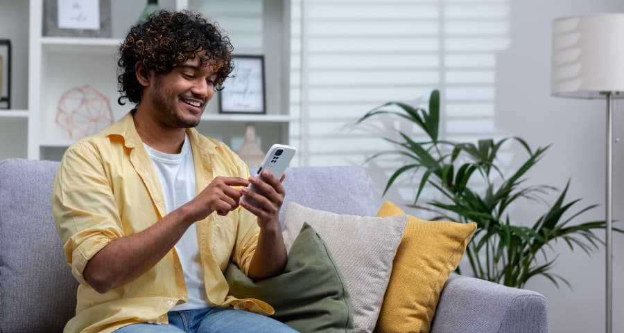 Man accessing a home security app on his cell phone